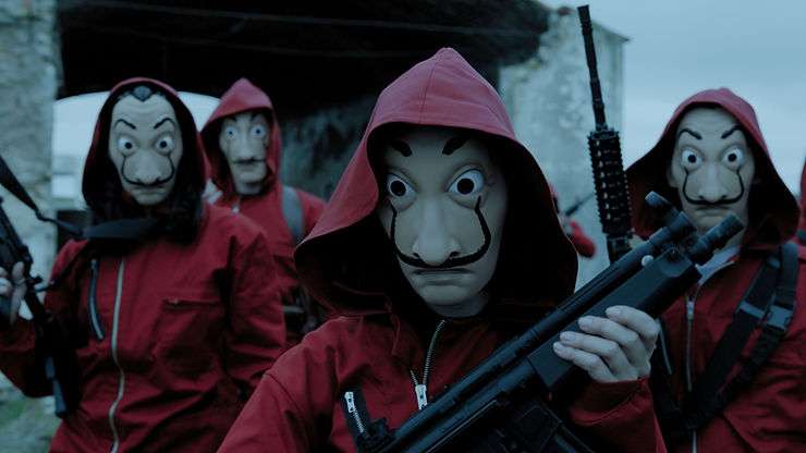 A still from Money Heist (La Casa de Papel) showing the robbers dressed in red overalls and Salvador Dali masks