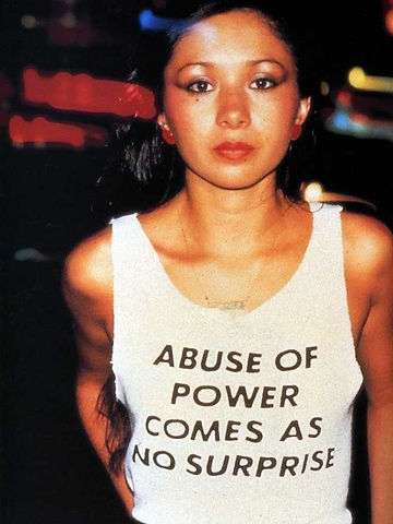 ‘Abuse of Power Comes As No Surprise’ from the series ‘Truisms’. Jenny Holzer.  T-shirts,1980-, worn by Lady Pink © 1983 Lisa Kahane, NYC.   Image credits: Tate Museum.